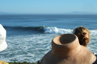 A surfer on a big wave off Lighthouse Point.