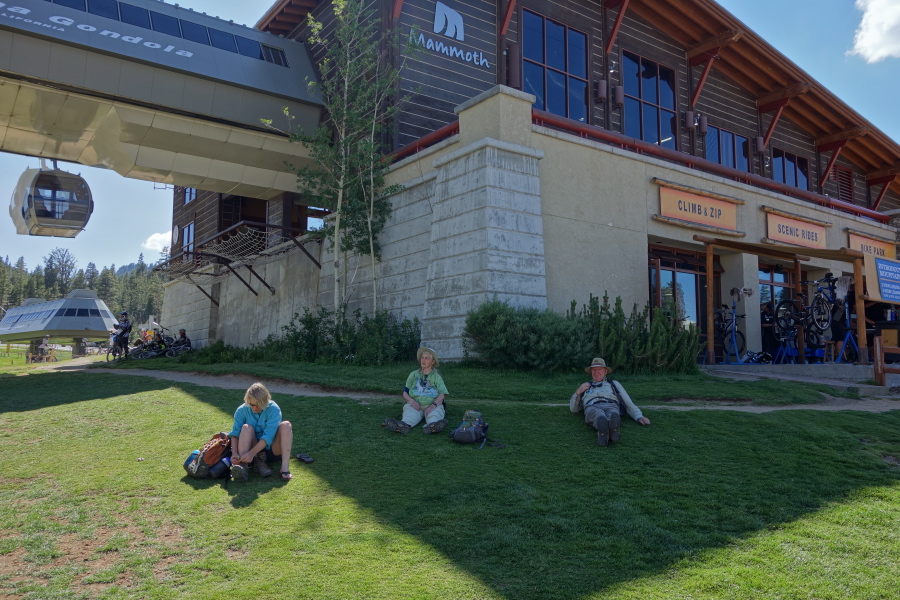 Nancy, Madie, and Brian rest on the lawn at the end of the shuttle ride.