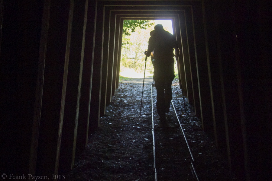 Bill ducks his head as he walks out of the mine shaft.