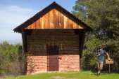 Gino stands before the Powder House.