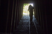 Bill ducks his head as he walks out of the mine shaft.