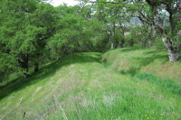 Old road alignment of Cinnabar Trail continues down out of the park.