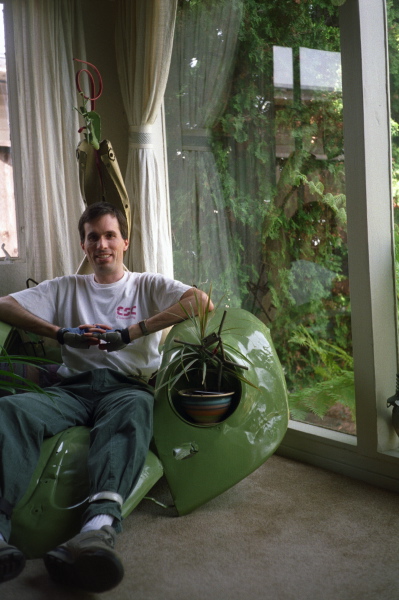 Bill sits in one of the sculptures, the hood of a VW bug.