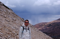Bill on the sloper of North Peak in front of the approaching tempest.