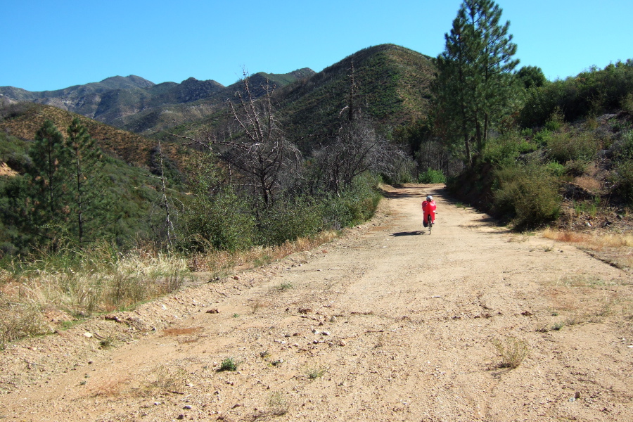 Ron crosses the ridge on a broad and smooth road.