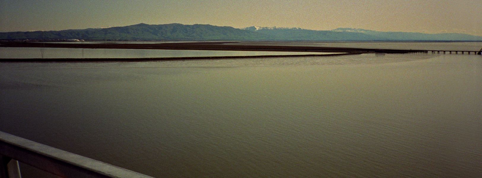 Still water on the bay; snow on the hills.