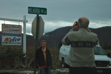Laura poses in front of the sign for Milaura Road.