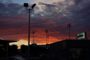 Sunrise over the Dollar Rent-A-Car lot.