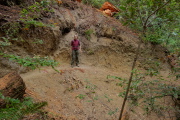 Bill stands on the trail at recent slide.