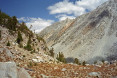 David rests on a rock at Chocolate Pass.