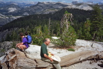 David rests on a log before starting the exposed part of the hike up Clouds Rest.