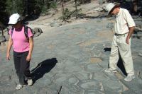 Stella and David walk atop the Postpile.