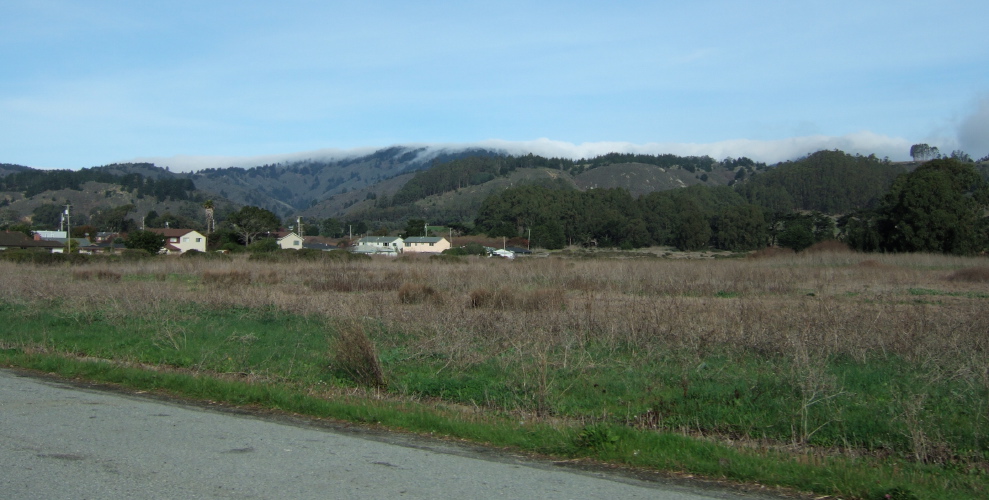 An unusual sight: Cold valley fog pushing over Montara Mountain from the east!