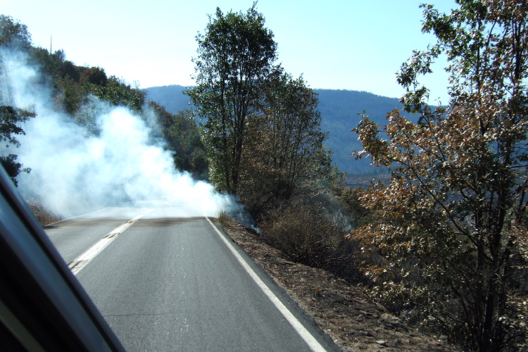 Hot spot smoke blowing across the road.