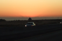 Sunrise on the Sierra peaks casting shadows into the haze.