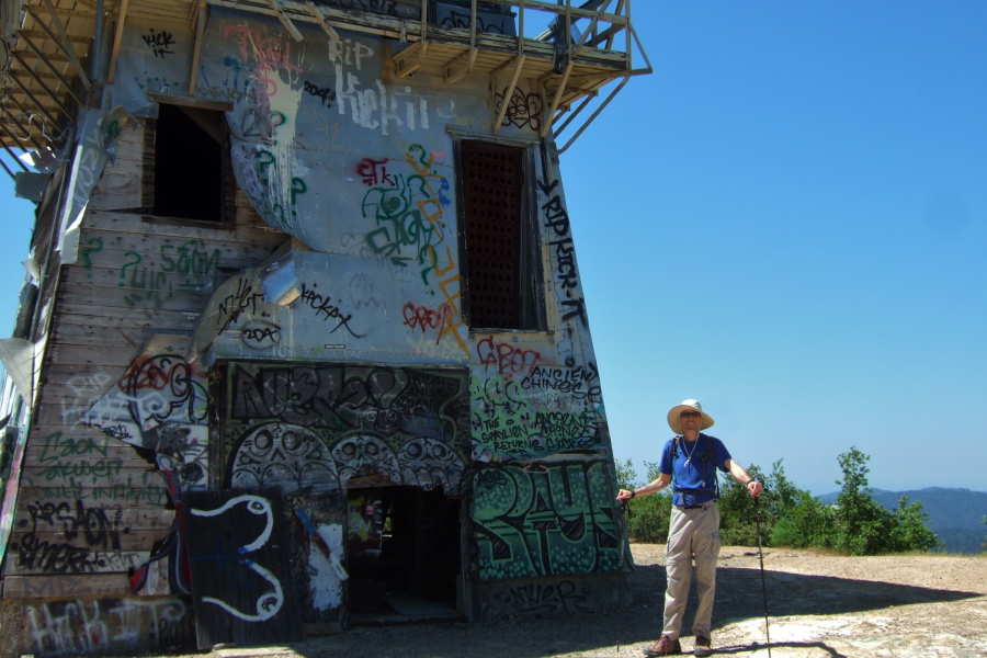 Bill stands before the lookout tower.