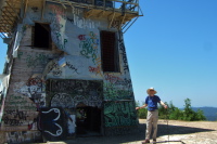 Bill stands before the lookout tower.