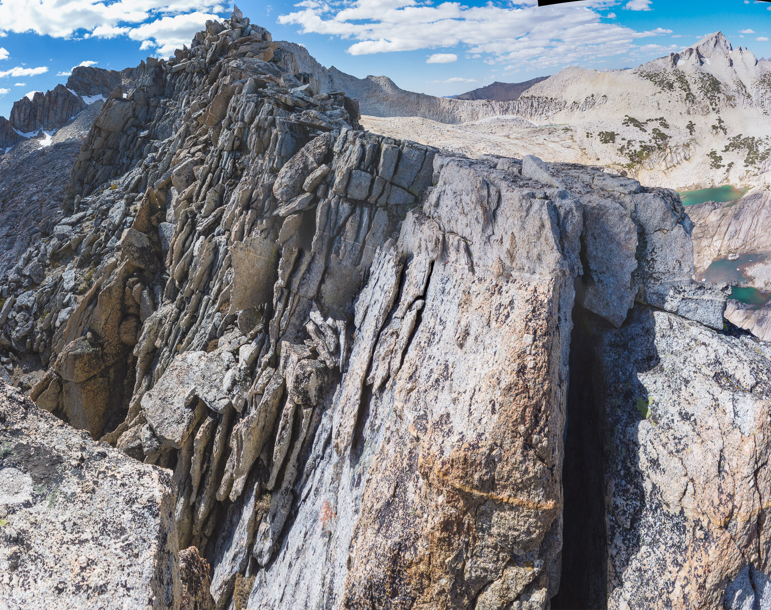 We reach a narrow spot on the ridge that requires crossing a deep notch, then continuing atop a narrow arete.