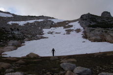 Bill waits for David, Stella, and Frank at the base of the broad chute, most of which is filled with snow.