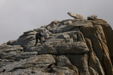 Bill climbs up the final blocks to the summit area.