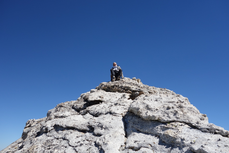Frank scoots down the rough granite.