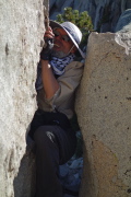 Frank and all of his equipment squeeze through the crack again.