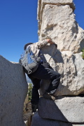 Frank climbs over the gap to avoid removing his pack.