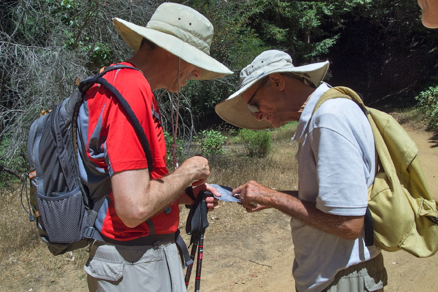 David and Bill examine the map before David returns the shortest way to the car.