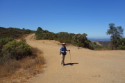 Frank stands again at the crossing of Priest Rock and Limekiln Trails.