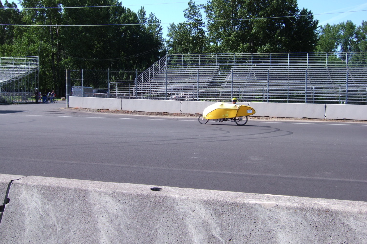 Bill rides the wrong way down the track to the starting line.