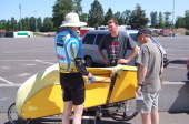 Bill discusses his bike with a couple of spectators.