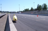 Bill rides up alongside the wall near the finish area.