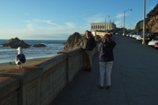 Lisa photographs Len near the Cliff House.
