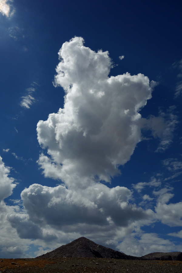 A cloud forms over a peak.