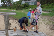 Heather ties Ed's shoe.