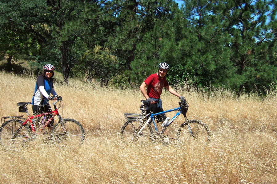 Mike Ahern and Tanya walk their mountain bikes up the Monument Trail.