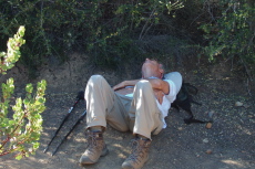 David rests by the trail in a spot of shade.