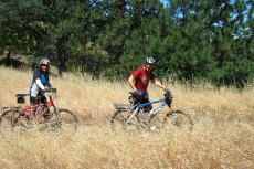 Mike Ahern and Tanya walk their mountain bikes up the Monument Trail.