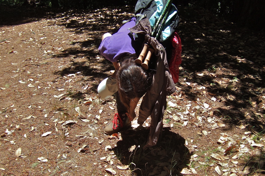 Stella wrings the water out of the cuffs of her pants.