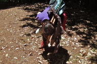 Stella wrings the water out of the cuffs of her pants.