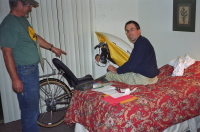 Ron points out something on Bill's bike.