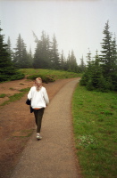 Kay walks quickly down the trail back to the parking lot.
