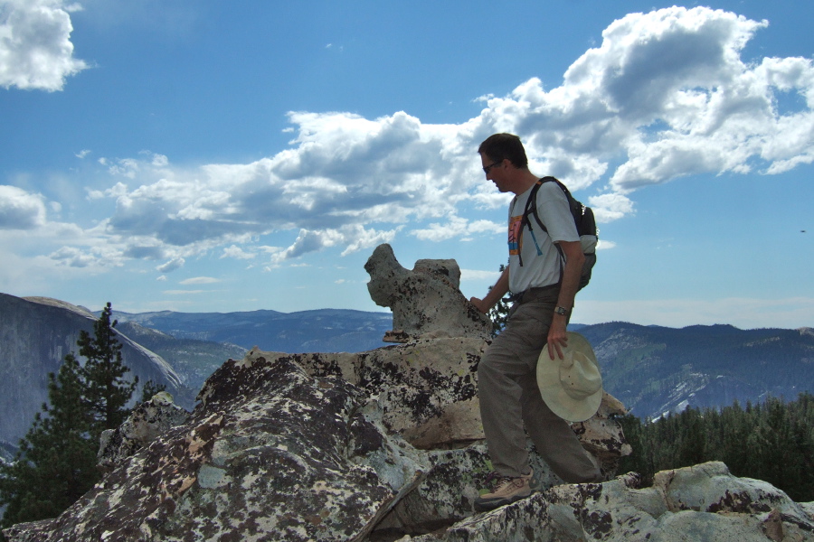 Bill examines the large bric-a-brac like rock shaped like a camel or a dog at the Indian Ridge viewpoint.