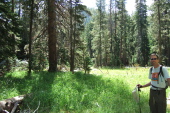 Bill at a lush meadow along the trail