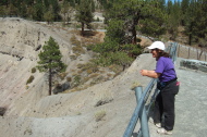Stella stands at the crater rim.