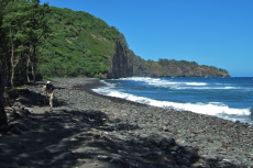 David walks along the rocky end of Pololu Beach.