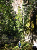 Kay and David hike back up Last Chance trail under the cliffs of the canyon walls.