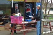 Kevin Winterfield (l) and Howard Kveck clean up the check-in area.