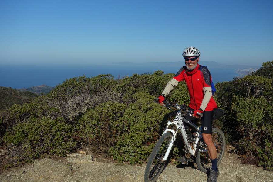 Frank reaches the top of North Peak on his bike.