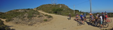 Finishers gather behind the finish line (at center of photo) below the West summit.
